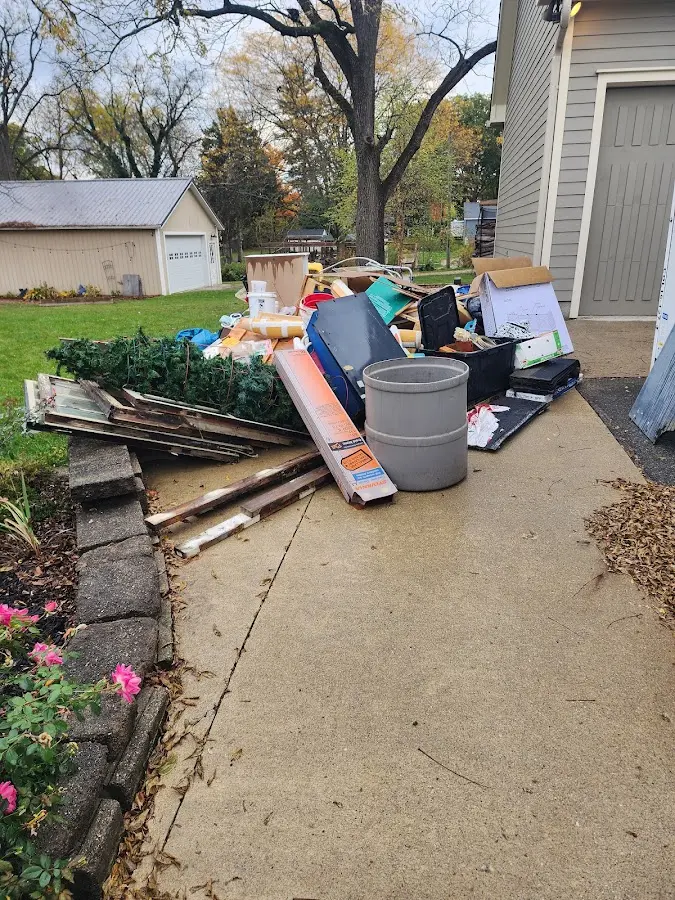 Dumpster being loaded with debris for Estate Cleanout Dumpster Rental in Dickson